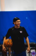 WSA coach in black shirt and glasses, smiling during practice