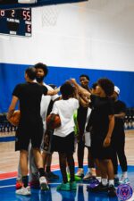 Full group hands-in huddle breaking down at the end of practice